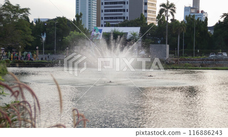 Realistic City fountain or water fountain at the lake using water jet pump spraying spray in the air. Realistic City fountain or water fountain at the lake using water jet pump spraying spray in the air. 116886243