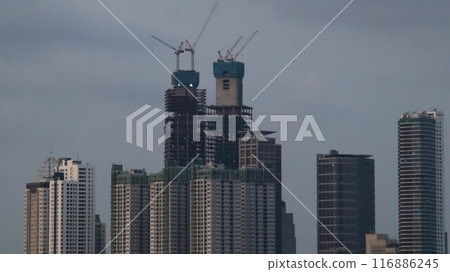 Photo of skyscraper high rise building construction in the middle of the city. 116886245