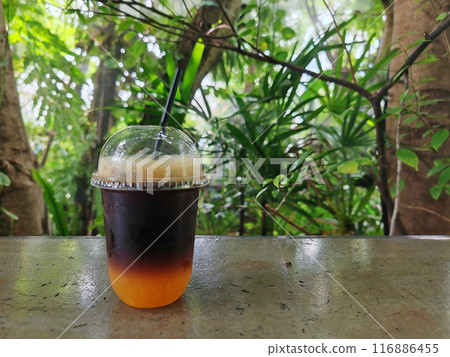 iced americano coffee mix with orange juice at cafe outdoor garden 116886455