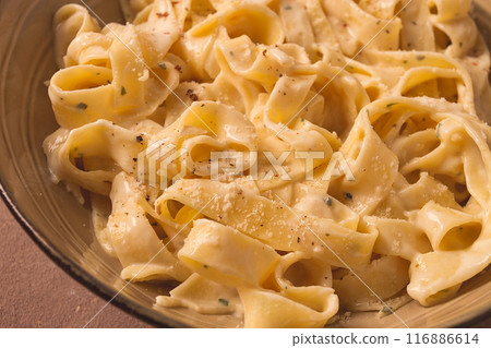 Fettuccine, tagliatelle, in creamy garlic sauce, Italian traditional cuisine, pasta carbonaro, 116886614