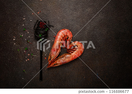 black spaghetti , wrapped on a fork, langoustines in the shape of a heart, on the table, dish concept, dish background, top view, black spaghetti , wrapped on a fork, langoustines in the shape of a heart, on the table, dish concept, dish background, top view, 116886677