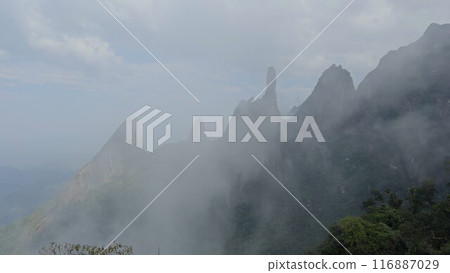 Breathtaking mountain peaks and lush jungle under drifting clouds Breathtaking mountain peaks and lush jungle under drifting clouds 116887029
