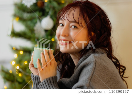 young woman with christmas tree young woman with christmas tree 116890137