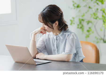 Young woman using a personal computer Young woman using a personal computer 116890170