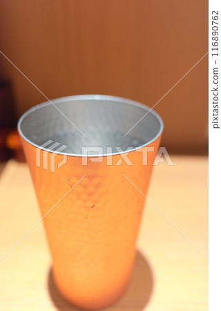 Handmade copper cup on a table 116890762