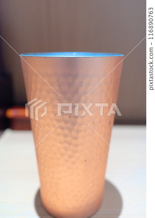 Handmade copper cup on a table Handmade copper cup on a table 116890763