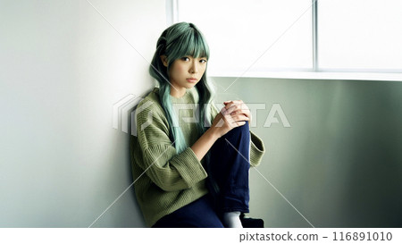 A woman tired of waiting at school after school 116891010