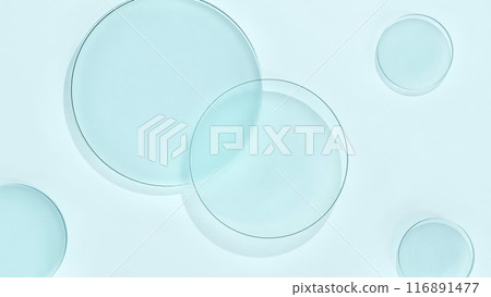 Round glass floating on light blue background Round glass floating on light blue background 116891477