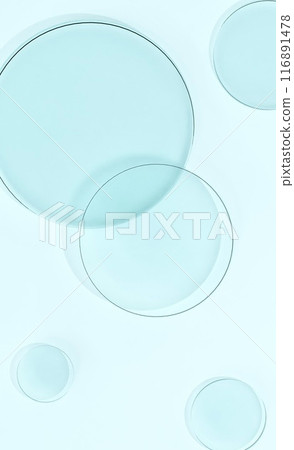 Round glass floating on light blue background Round glass floating on light blue background 116891478