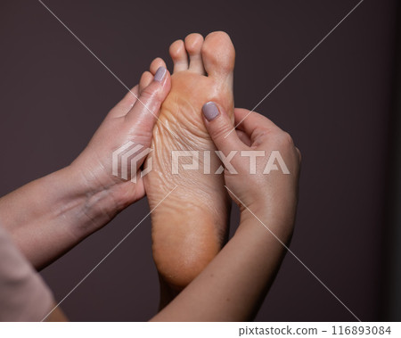 Close-up of a woman's foot massage. Vertical photo. Close-up of a woman's foot massage. Vertical photo. 116893084