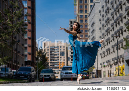 Beautiful Asian ballerina dancing outdoors. Urban landscape. 116893480