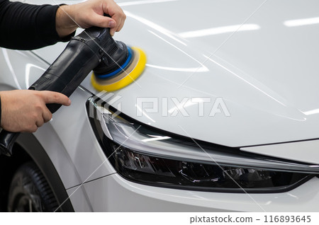 Process of polishing white car hood surface using orbital polishing machine. Process of polishing white car hood surface using orbital polishing machine. 116893645