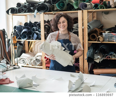Woman tanner at work in the workshop. Woman tanner at work in the workshop. 116893697