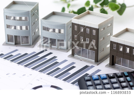 Corporate office building with graphs and calculator 116893833