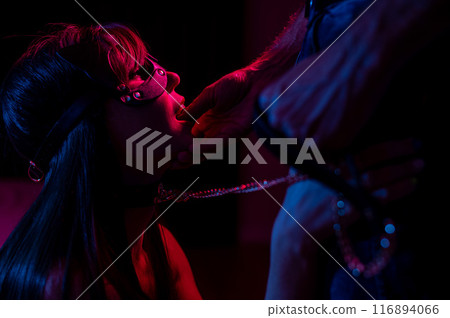 Role-playing games. Man putting finger in woman's mouth in cat mask. Role-playing games. Man putting finger in woman's mouth in cat mask. 116894066