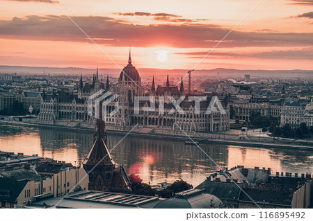 The Hungarian Parliament on the Danube River at dramatic Sunrise in Budapest The Hungarian Parliament on the Danube River at dramatic Sunrise in Budapest 116895492