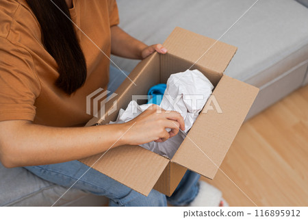 shopaholic revels in her parcel of fashion treasures, confirming delight via e-commerce and speedy online shopping shopaholic revels in her parcel of fashion treasures, confirming delight via e-commerce and speedy online shopping 116895912