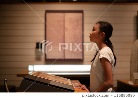 一個女孩認真地看著展品 116896080