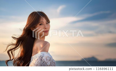 A woman relaxing on the beach at dusk 116896111
