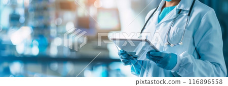 Doctor using digital tablet in modern medical facility. Technology in healthcare and professional medical services. 116896558