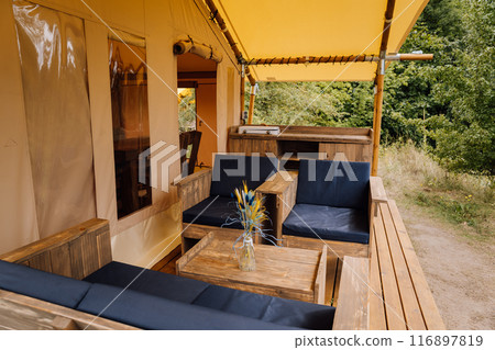 Interior of cozy open glamping tent. Camping tent for outdoor summer holiday and vacation 116897819