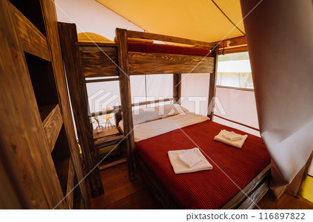 Interior of cozy open glamping tent. Camping tent for outdoor summer holiday and vacation 116897822