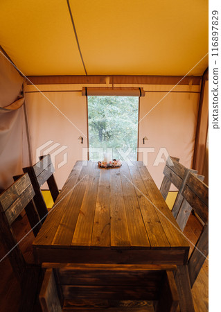 Interior of cozy open glamping tent. Camping tent for outdoor summer holiday and vacation 116897829