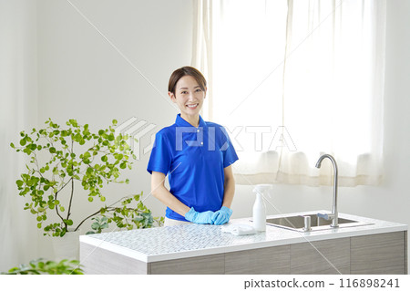 Portrait of a housecleaning woman cleaning the kitchen Portrait of a housecleaning woman cleaning the kitchen 116898241