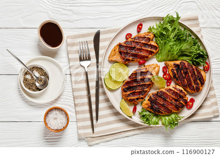 grilled chicken breasts wrapped in bacon on plate grilled chicken breasts wrapped in bacon on plate 116900127
