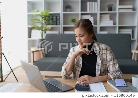 Woman Home Finance Management using calculator, computer and documents Mortgage to plan calculate Woman Home Finance Management using calculator, computer and documents Mortgage to plan calculate 116900149