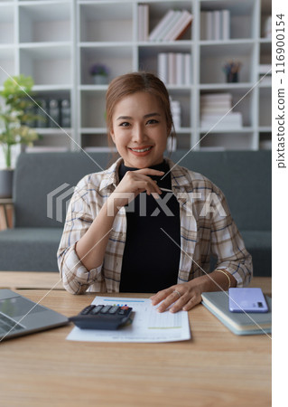 Woman Home Finance Management using calculator, computer and documents Mortgage to plan calculate Woman Home Finance Management using calculator, computer and documents Mortgage to plan calculate 116900154