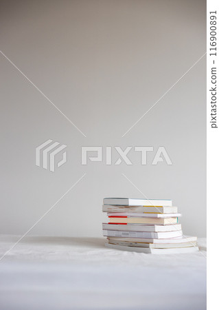 Many books stacked on the bed Many books stacked on the bed 116900891