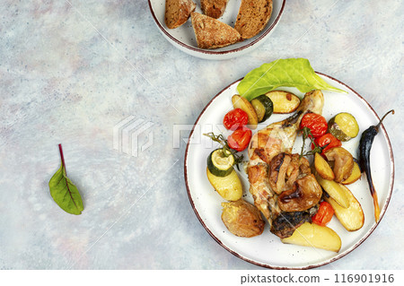 Chicken legs baked with potatoes. 116901916