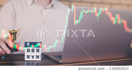 Businessman uses laptop to invest in real estate with growth stability chart. Double exposure 116902021