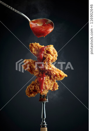 Fried chicken wings with tomato sauce. 116902646