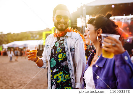 Group of friends with beer dancing and having fun at music festival together. Summer Beach party. 116903378