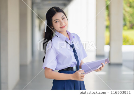portrait school uniform teen girl standing happy smile indoor school campus for learning education back to school concept. 116903931