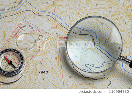 Map, magnifying glass and compass 116904880