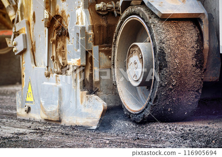 The machine removes and cuts off a layer of old asphalt. Road repairs The machine removes and cuts off a layer of old asphalt. Road repairs 116905694