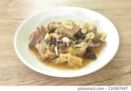 steamed pork rib with chop ginger and black ear mushroom topping garlic in soy sauce on plate steamed pork rib with chop ginger and black ear mushroom topping garlic in soy sauce on plate 116907497