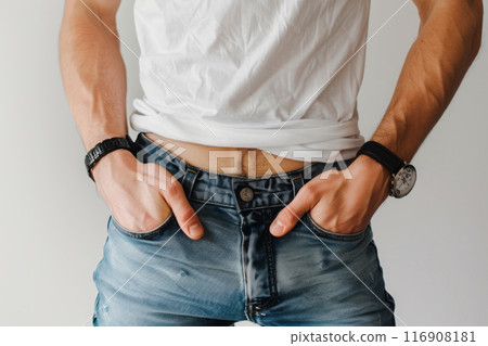 Man posing with hands in pockets of jeans, showing casual clothes 116908181