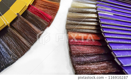 A palette of hair colors made from artificial strands on a white background 116910287