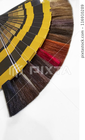 A palette of hair colors made from artificial strands on a white background 116910289