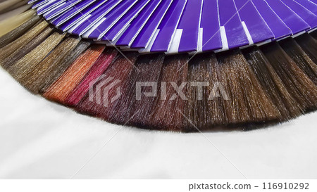 A palette of hair colors made from artificial strands on a white background 116910292