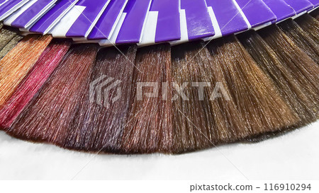 A palette of hair colors made from artificial strands on a white background 116910294