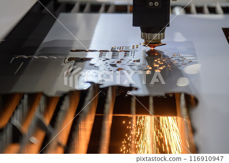 The fiber laser cutting machine  cut the metal plate with the sparkling light. 116910947