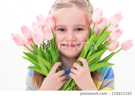 Cheerful beatiful little girl with a armful of colorful flowers, on white background 116911283