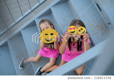 Children with a variety of emojis displaying different emotional states Children with a variety of emojis displaying different emotional states 116911336