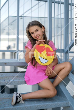 A girl shares her love with the world through emoticons 116911343