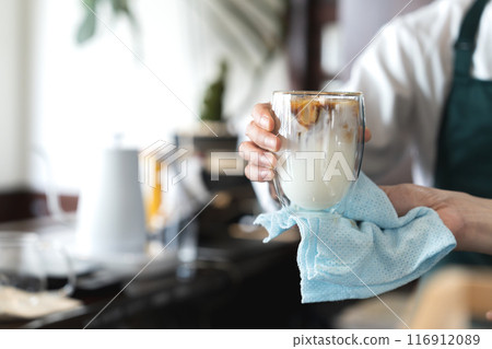 A man serving cafe au lait A man serving cafe au lait 116912089